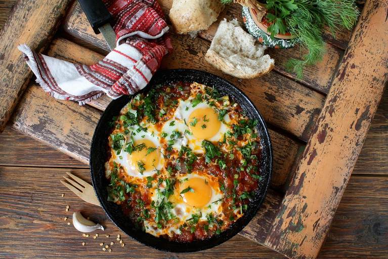 Fried eggs served with crumbled goat cheese for breakfast