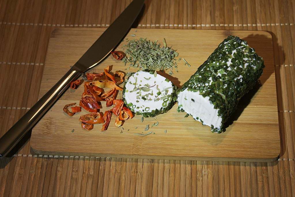 Fresh goat cheese served on a wooden board